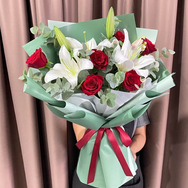 Elegant red rose and white lily bouquet with eucalyptus greenery by Giflorist, perfect for romantic occasions.